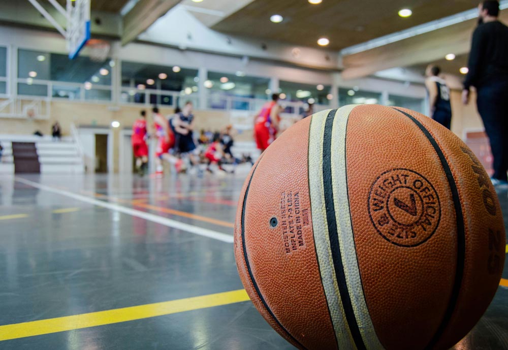 Basketball rests on indoor basketball court